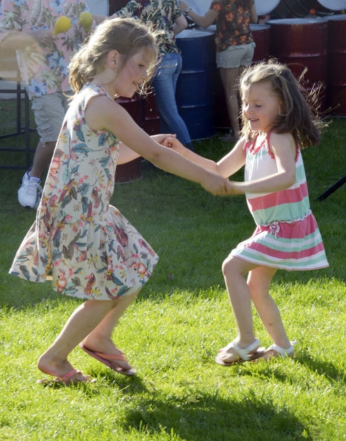 Two girls dance to the music at Petoskeys' concerts in the park.