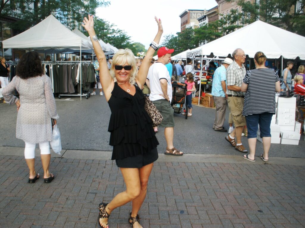 A happy shopper in petoskey sidewalk sales.