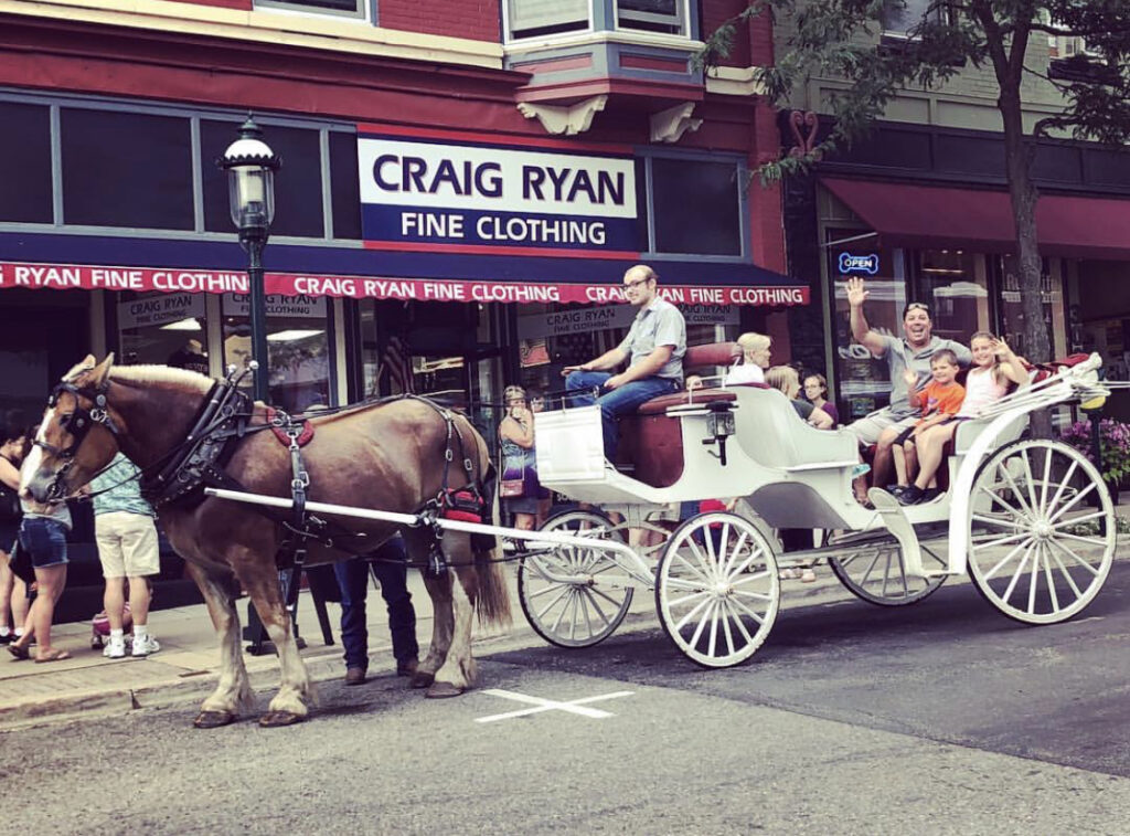 Summer returns. A family rides in a horse-drawn carriage