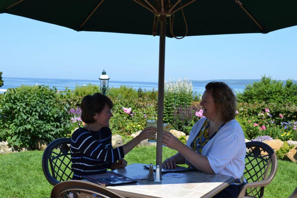 Summer Returns to Petoskey. Enjoy a drink in the Rose Garden of the Stafford Perry Hotel